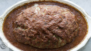 A baked and ready to slice Italian meatloaf.