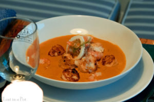 Plating of the seafood bisque.