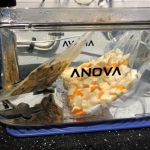 Veggies and mussels reheating in the sous vide. Veggies and mussels reheating in the sous vide.