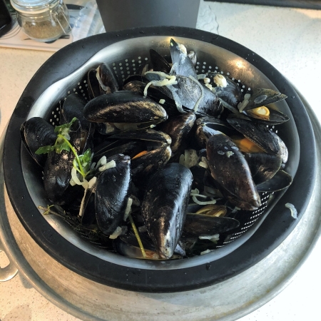 Steamed mussels draining. Steamed mussels draining.
