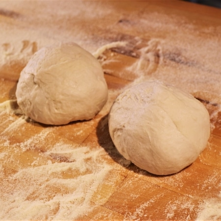 Pizza dough after being rolled into balls.